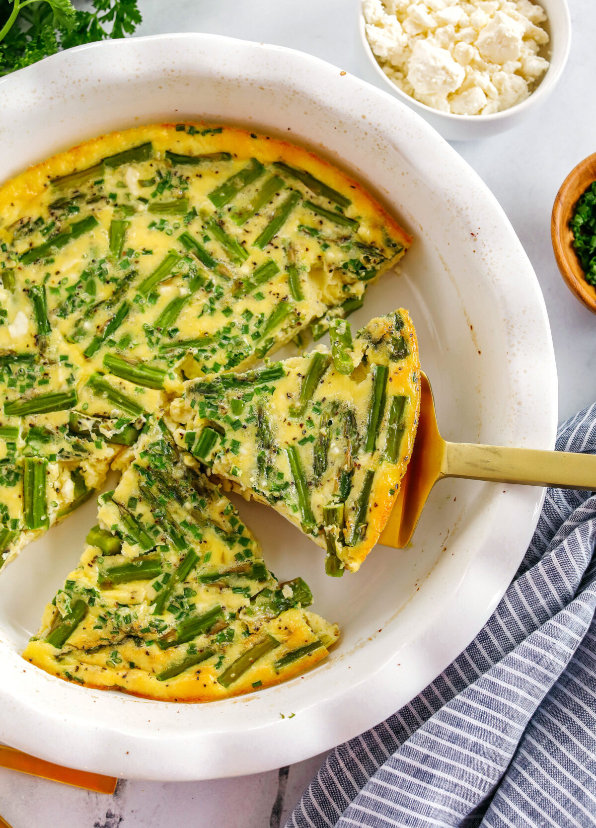 This healthy Asparagus and Feta Crustless Quiche is easily made with just a few simple ingredients, tastes delicious and makes the perfect low-carb dish you can enjoy for any meal!