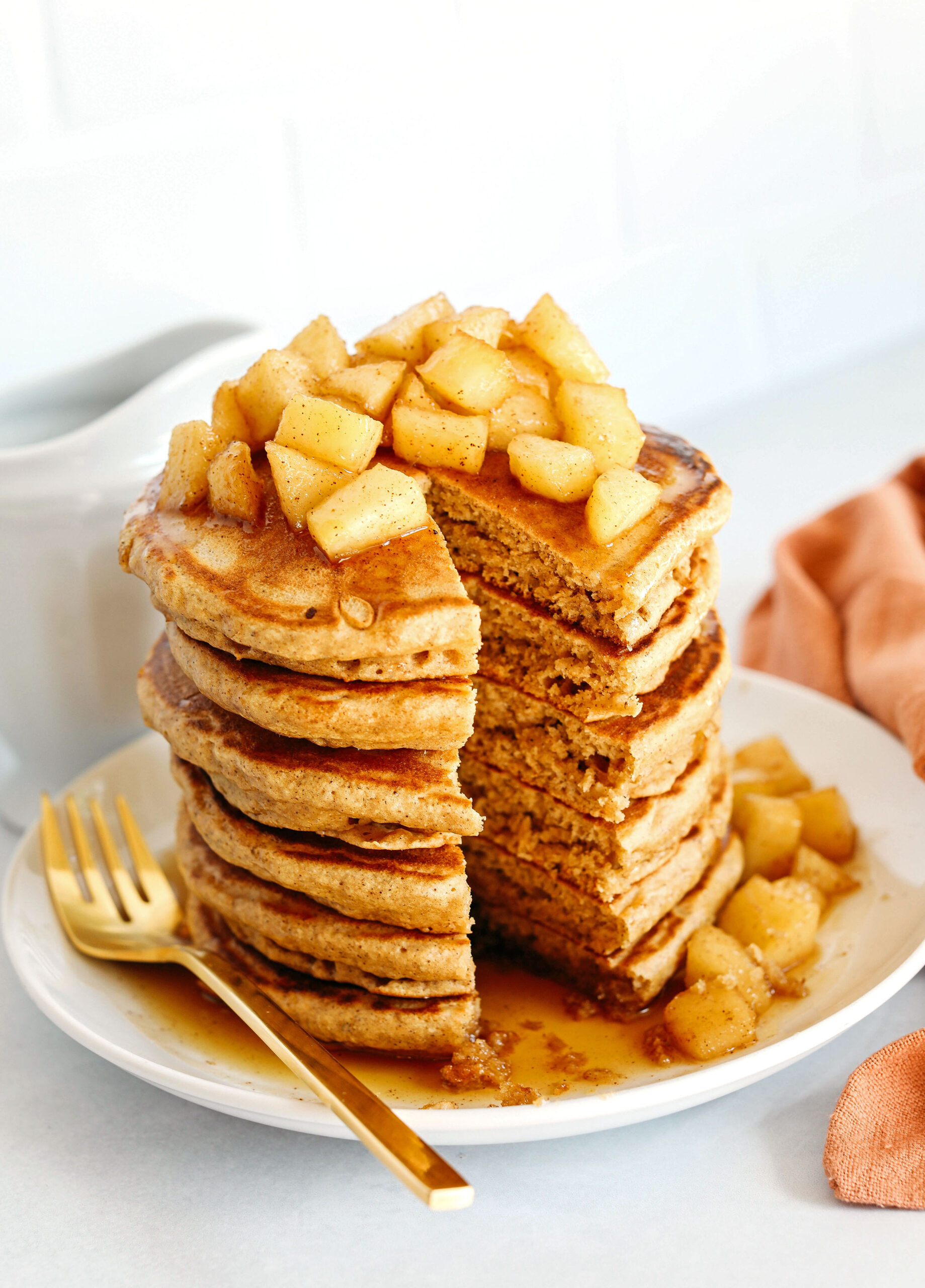 Light and fluffy Apple Cinnamon Pancakes made healthier with whole wheat flour, applesauce in place of oil and zero butter or refined sugar!  Topped with warm spiced apples and drizzled with maple syrup!