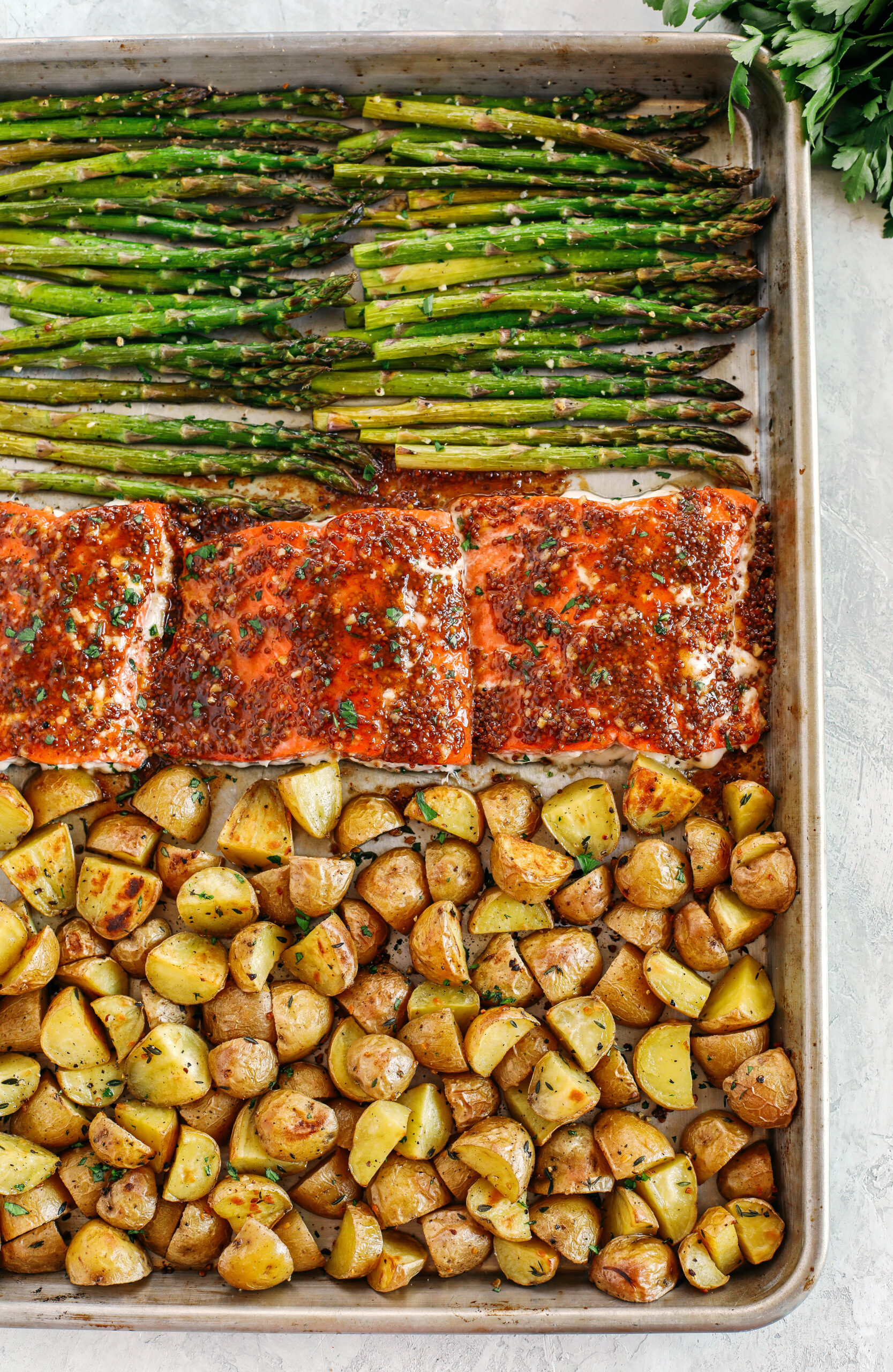 Sheet Pan Maple Dijon Glazed Salmon with roasted asparagus and tender seasoned potatoes make the perfect weeknight dinner that is easily made all in one pan in just 30 minutes!