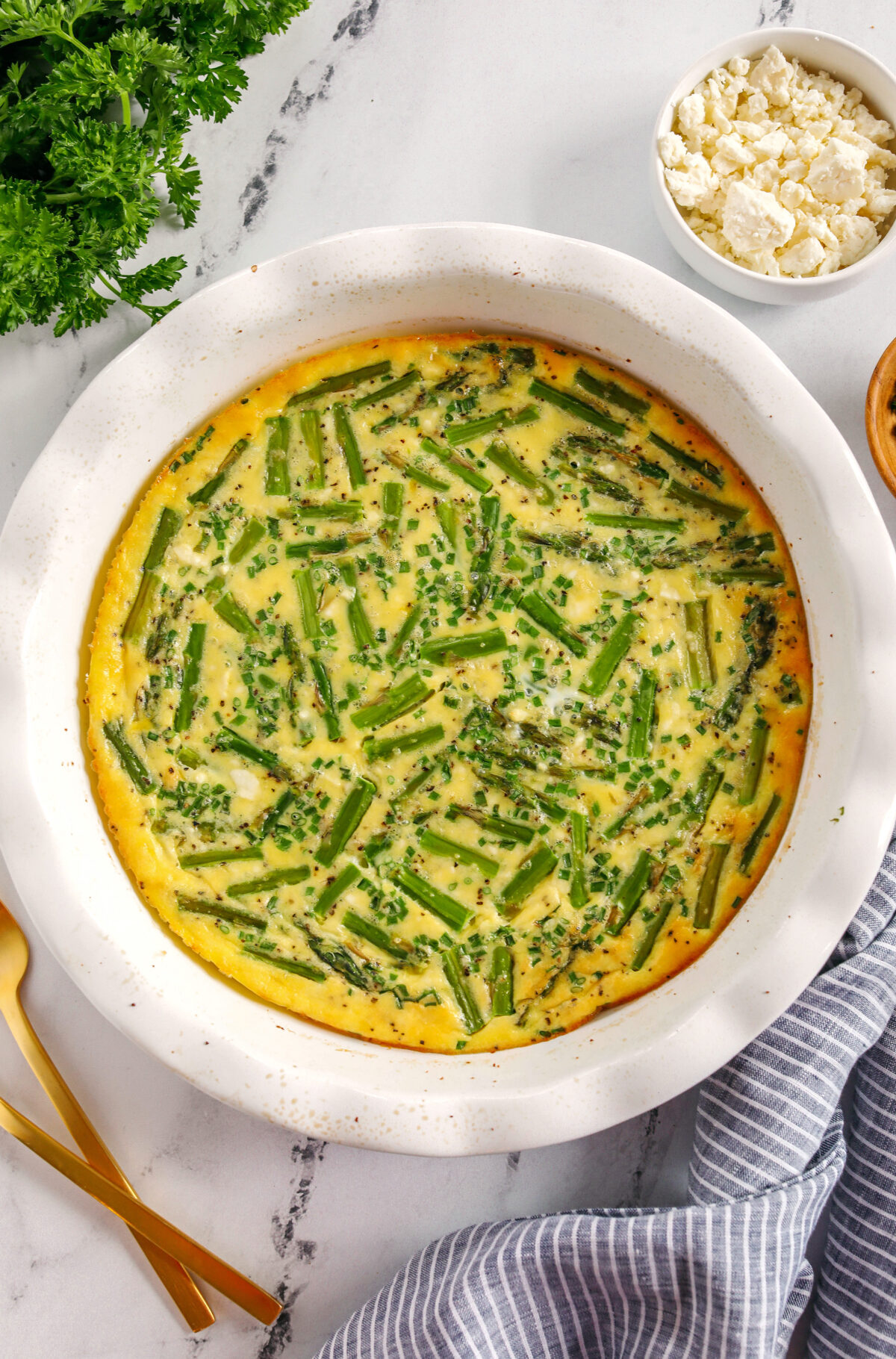 This healthy Asparagus and Feta Crustless Quiche is easily made with just a few simple ingredients, tastes delicious and makes the perfect low-carb dish you can enjoy for any meal!