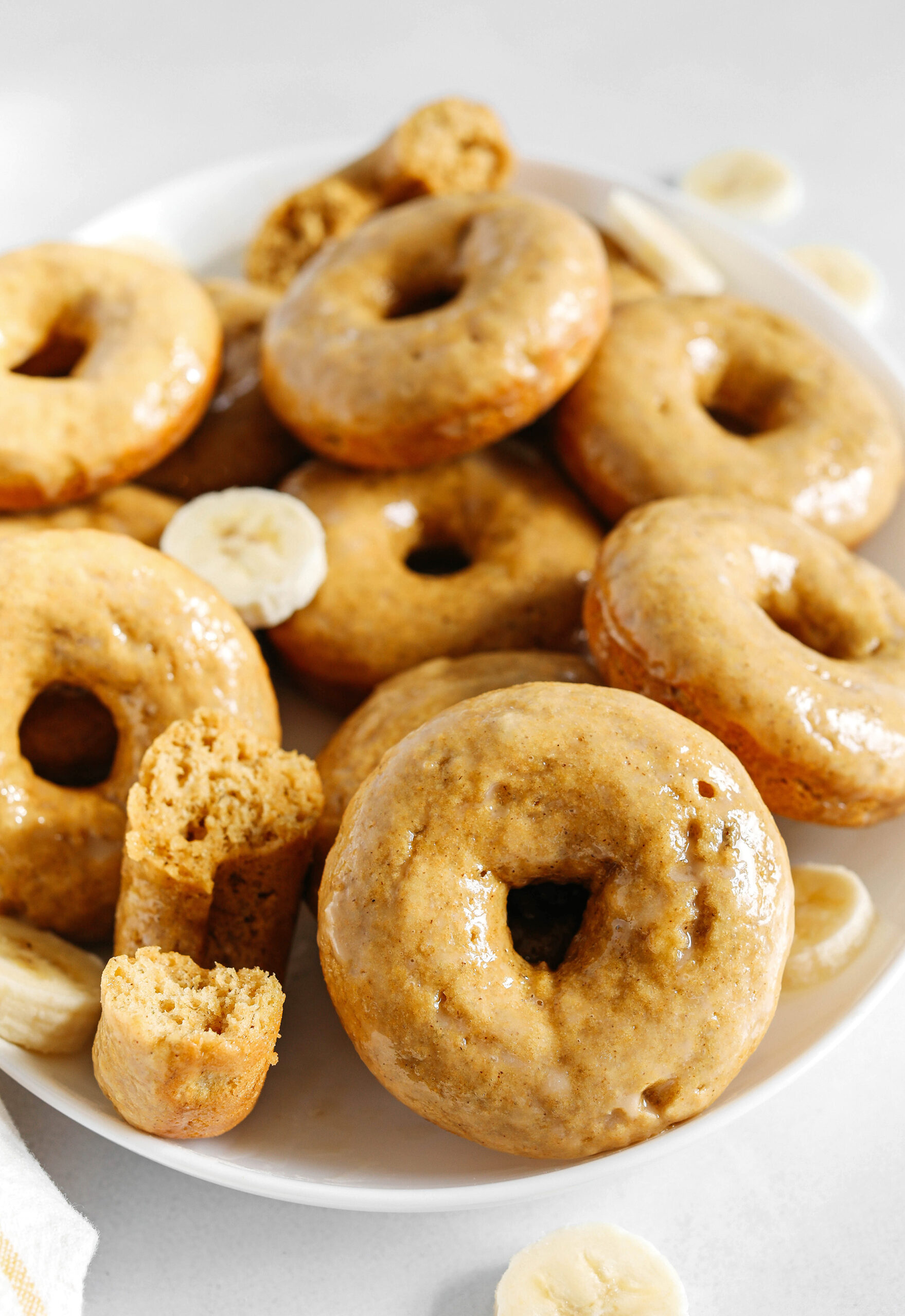 These Baked Banana Bread Donuts are soft, cake-like and made healthier with whole wheat flour, applesauce and zero refined sugar for the perfect morning treat that comes together in just 20 minutes!  Such a great way to use up those overripe bananas!