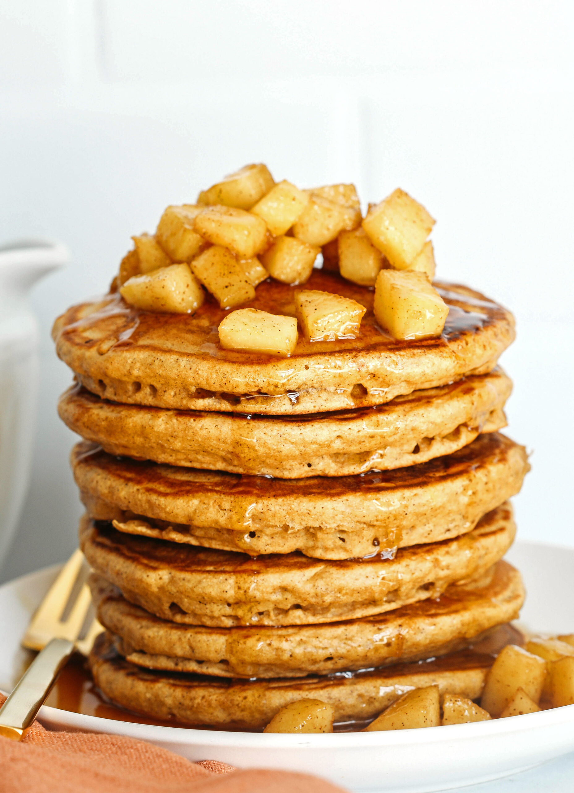 Light and fluffy Apple Cinnamon Pancakes made healthier with whole wheat flour, applesauce in place of oil and zero butter or refined sugar!  Topped with warm spiced apples and drizzled with maple syrup!