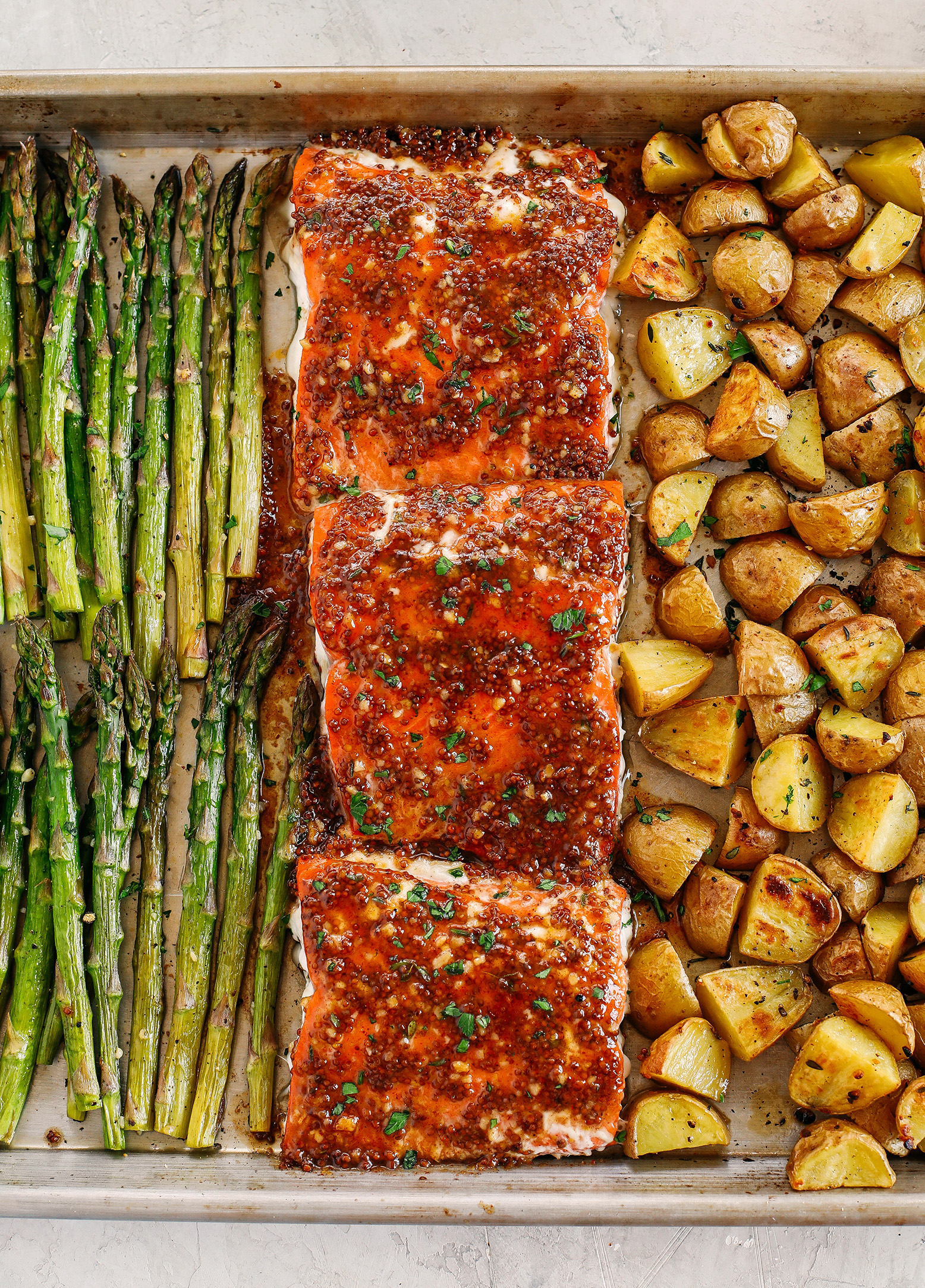 Sheet Pan Maple Dijon Glazed Salmon with roasted asparagus and tender seasoned potatoes make the perfect weeknight dinner that is easily made all in one pan in just 30 minutes!